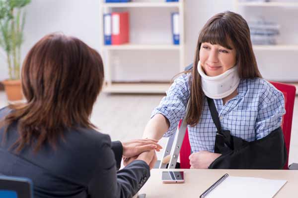 a woman meeting with a Denver Personal Injury Lawyer